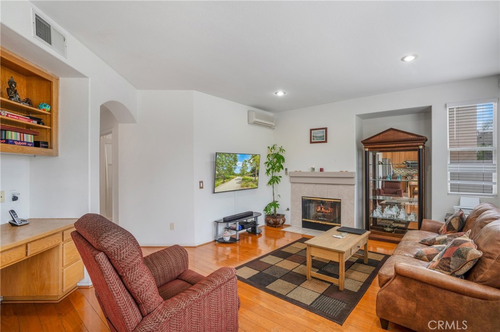 8946 Burlington Circle Riverside, CA 92508 - Photo 13 of 26 a living room with furniture a fireplace and a flat screen tv