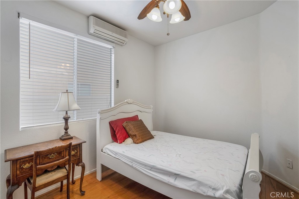 8946 Burlington Circle Riverside, CA 92508 - Photo 15 of 26 a bedroom with a bed and a chandelier