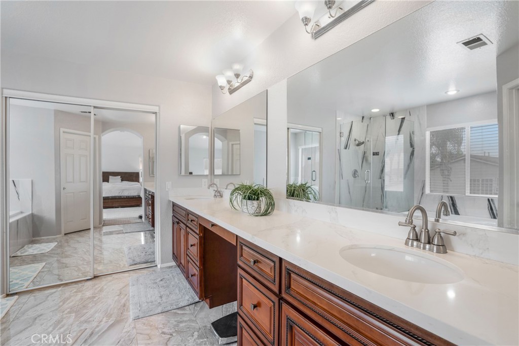 8946 Burlington Circle Riverside, CA 92508 - Photo 20 of 26 a spacious bathroom with a double vanity sink a large mirror and a shower