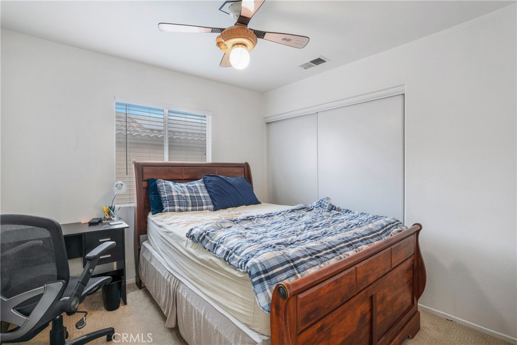 8946 Burlington Circle Riverside, CA 92508 - Photo 22 of 26 a bed sitting in a bedroom next to a window