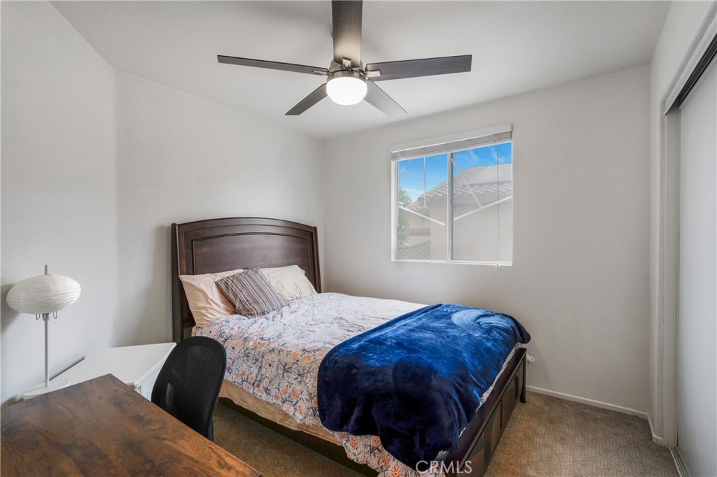 8946 Burlington Circle Riverside, CA 92508 - Photo 23 of 26 a bedroom with a bed and window