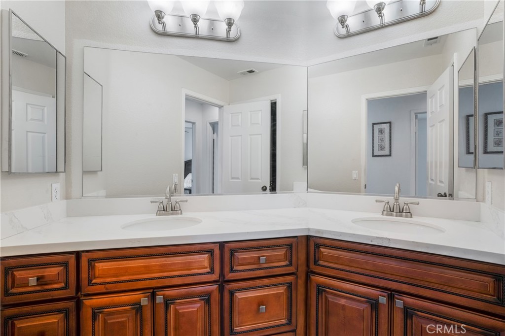 8946 Burlington Circle Riverside, CA 92508 - Photo 25 of 26 a bathroom with a sink double vanity and a mirror