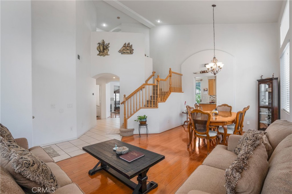8946 Burlington Circle Riverside, CA 92508 - Photo 8 of 26 a living room with furniture a dining table and a chandelier