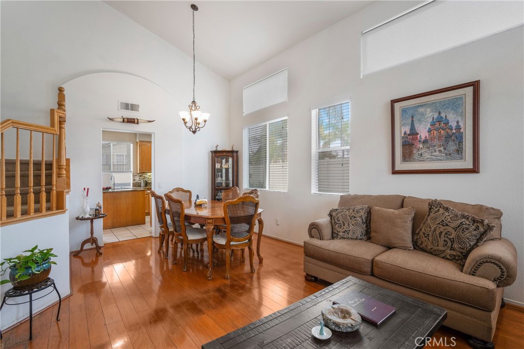 8946 Burlington Circle Riverside, CA 92508 - Photo 9 of 26 a living room with furniture or wooden floor and a chandelier