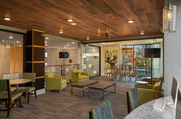 a living room with furniture a rug and a chandelier