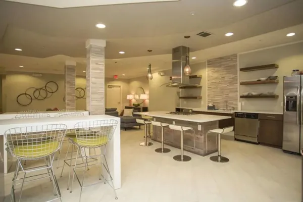 a large kitchen with a table and chairs