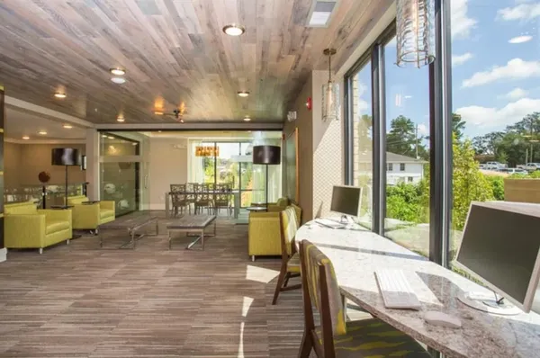 a view of a dining room with furniture a chandelier and wooden floor