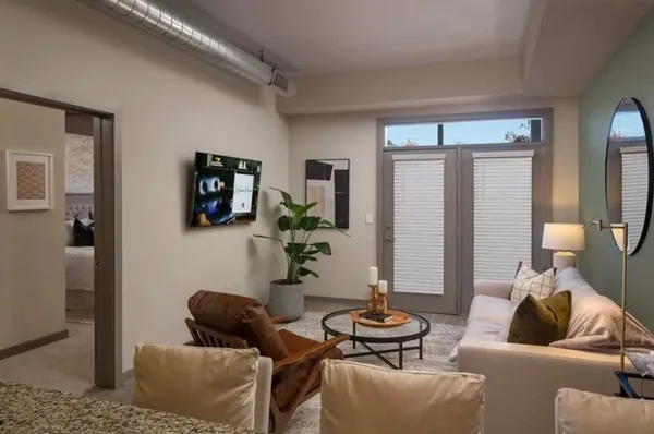 a living room with furniture and a wooden floor