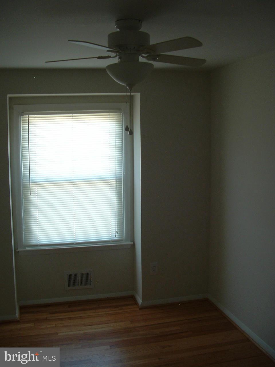 2129 Cockspur Road Baltimore, MD 21220 - Photo 22 of 27 a view of a small space with wooden floor and a window