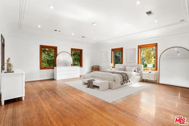 a bedroom with a large bed and a large window