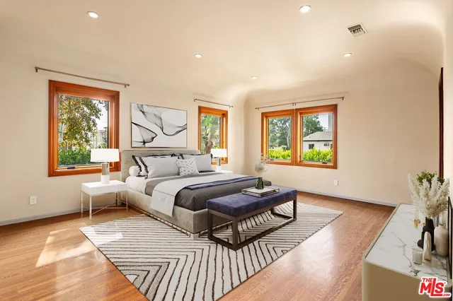 a bedroom with furniture and a window