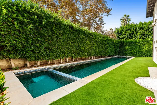 a view of a swimming pool with a yard