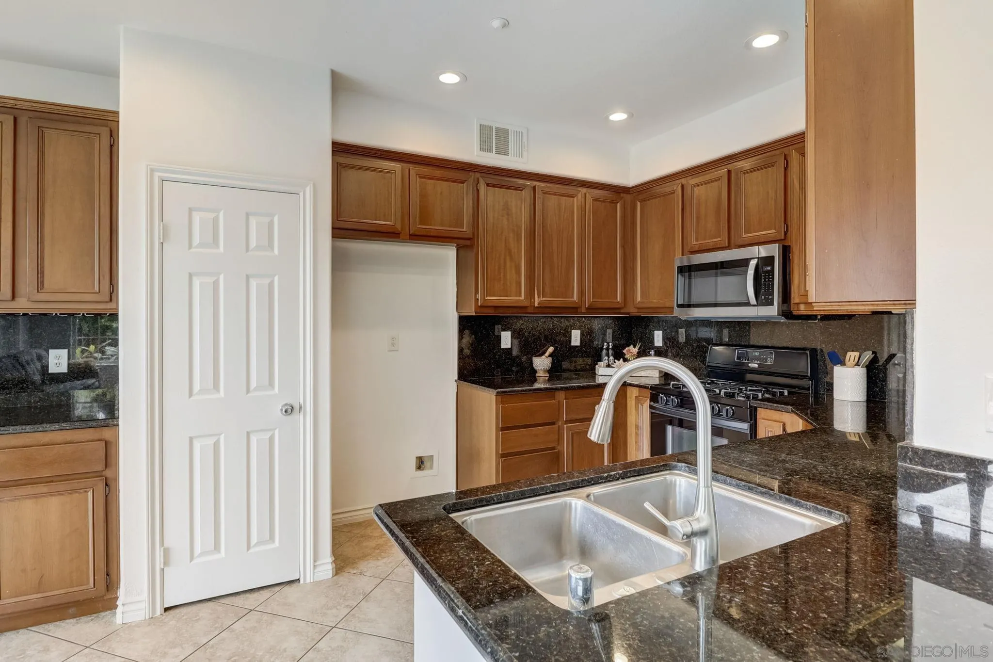648 Beach Street Encinitas, CA 92024 - Photo 12 of 31 a kitchen with stainless steel appliances granite countertop a sink a stove and a refrigerator