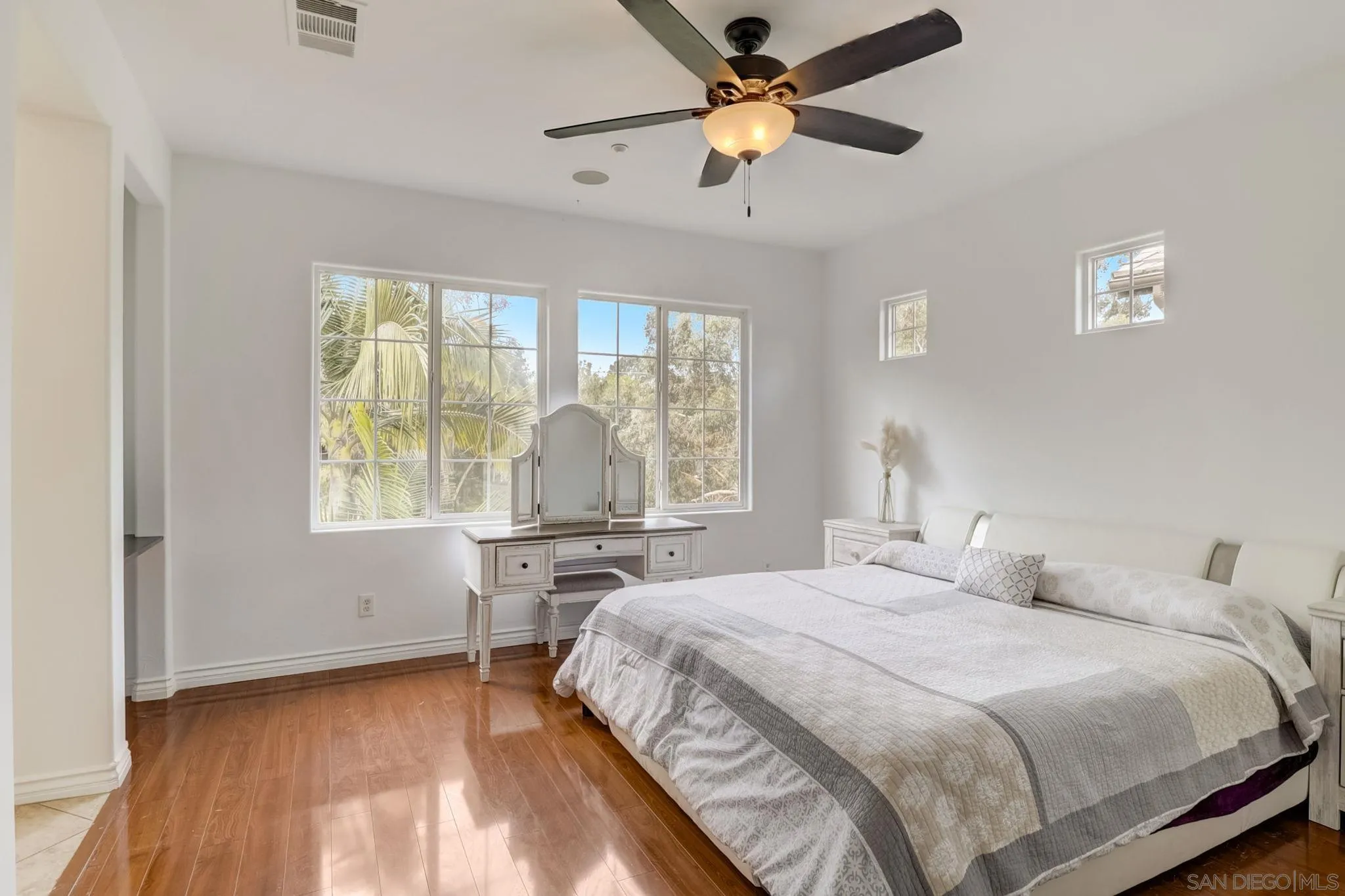 648 Beach Street Encinitas, CA 92024 - Photo 20 of 31 a bedroom with a large bed and a chandelier