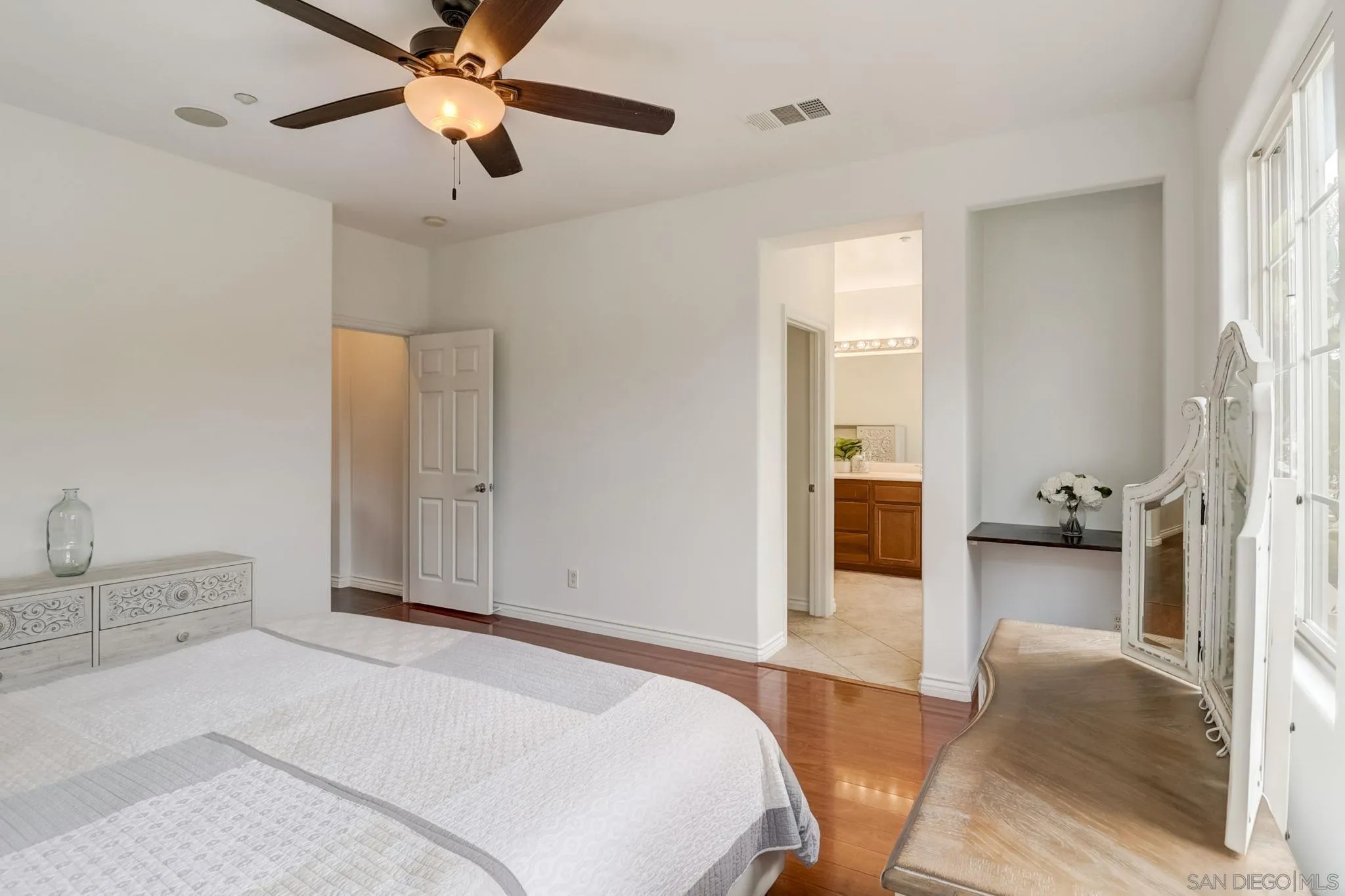 648 Beach Street Encinitas, CA 92024 - Photo 21 of 31 a spacious bedroom with a bed and a chandelier