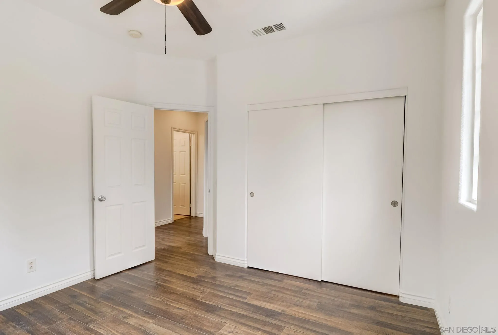 648 Beach Street Encinitas, CA 92024 - Photo 25 of 31 an empty room with wooden floor cabinet and windows