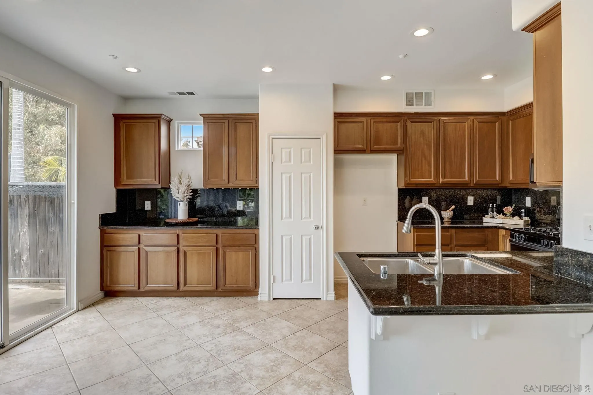 648 Beach Street Encinitas, CA 92024 - Photo 10 of 31 a kitchen with stainless steel appliances granite countertop a sink a stove and a refrigerator