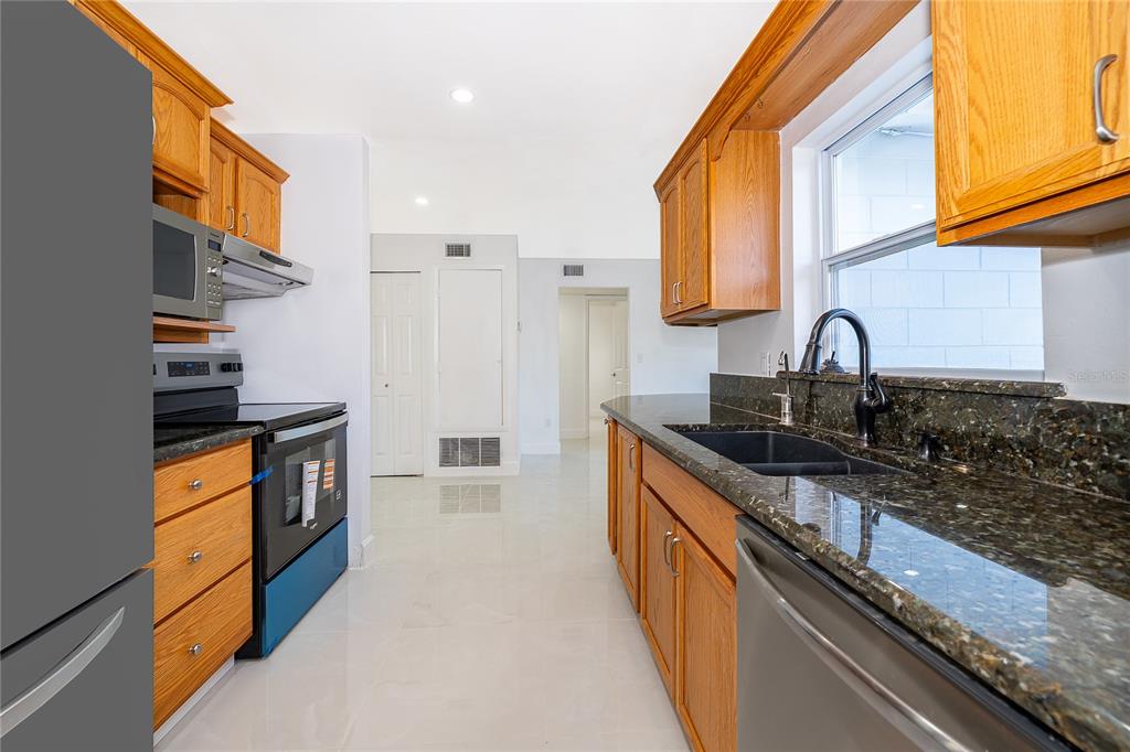 146 Exeter Avenue Longwood, FL 32750 - Photo 12 of 25 a kitchen with granite countertop a sink and a stove top oven