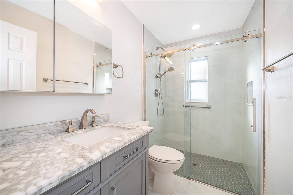 146 Exeter Avenue Longwood, FL 32750 - Photo 15 of 25 a bathroom with a granite countertop sink a toilet and shower