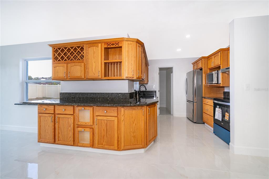 146 Exeter Avenue Longwood, FL 32750 - Photo 9 of 25 a view of a kitchen with a sink and a refrigerator