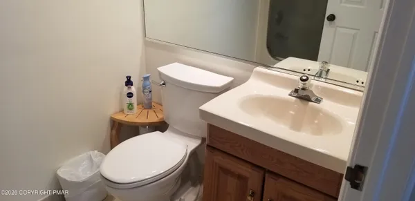 a bedroom with a bed a mirror and windows