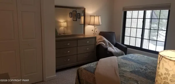 a bedroom with a bed and a window