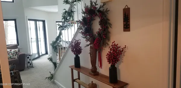 a vase of flowers sitting on a table in front of a window