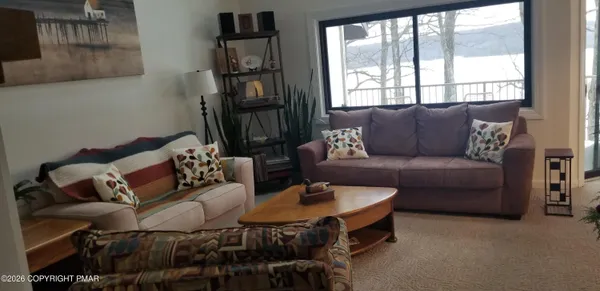 a living room with furniture and a book shelf