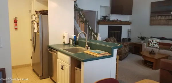 a kitchen with a sink a stove and a refrigerator
