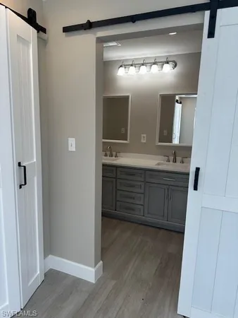 a bathroom with a double vanity sink and a mirror