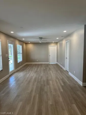 a view of empty room with wooden floor