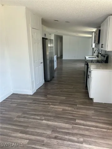 a view of a kitchen from the hallway