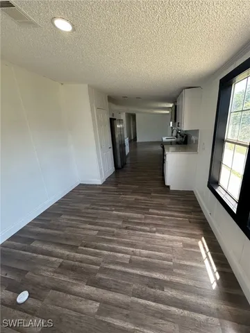 a room with a bed and large windows