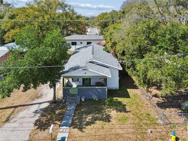 a view of a small house with a yard