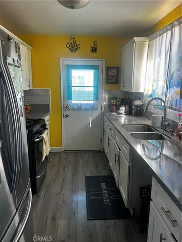 a kitchen with a sink appliances and cabinets