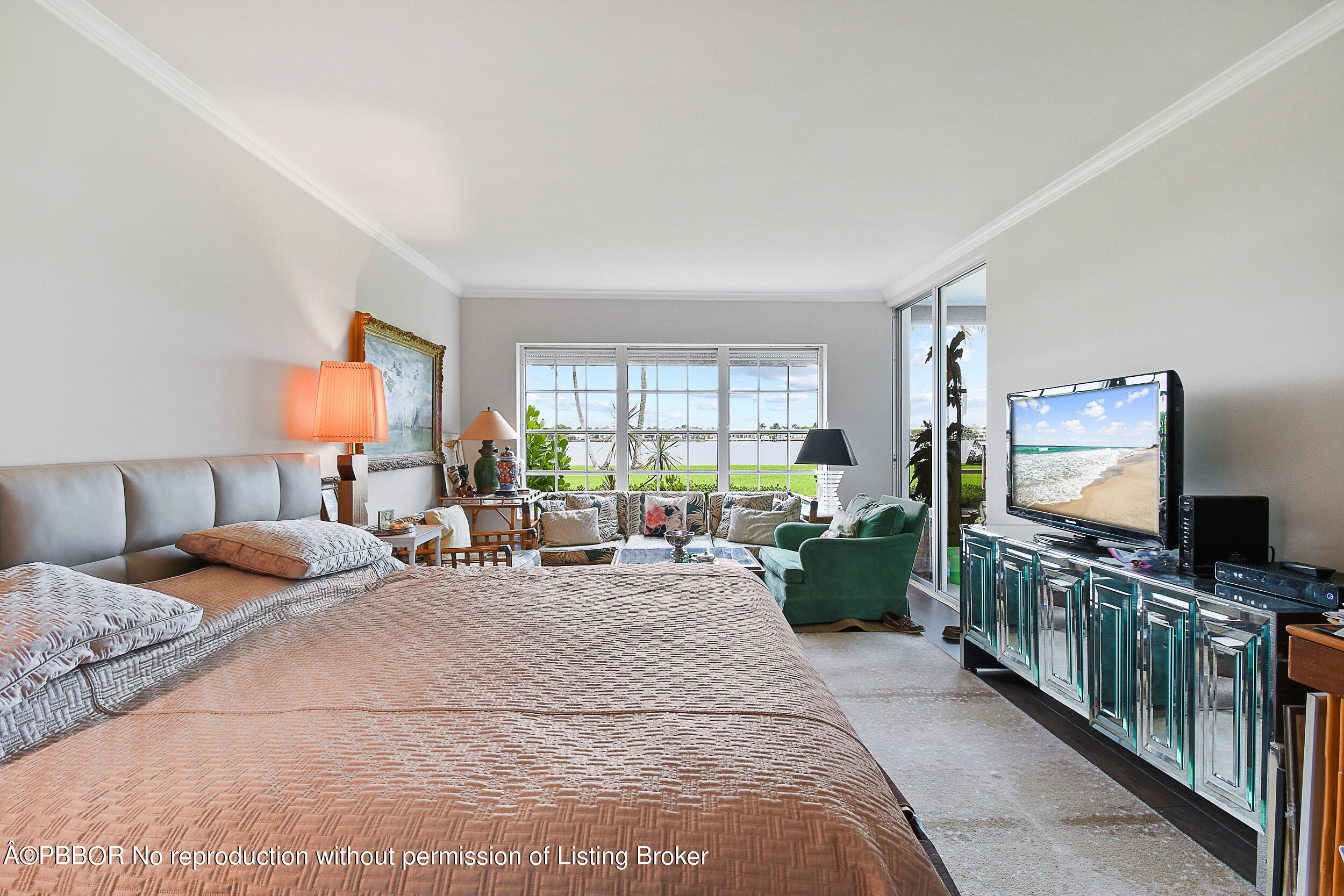 2170 Ibis Isle Road, Unit 2 Palm Beach, FL 33480 - Photo 13 of 38 a bedroom with furniture a flat screen tv and a window