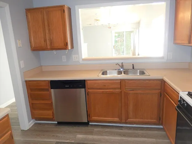 a kitchen with sink cabinets and a window