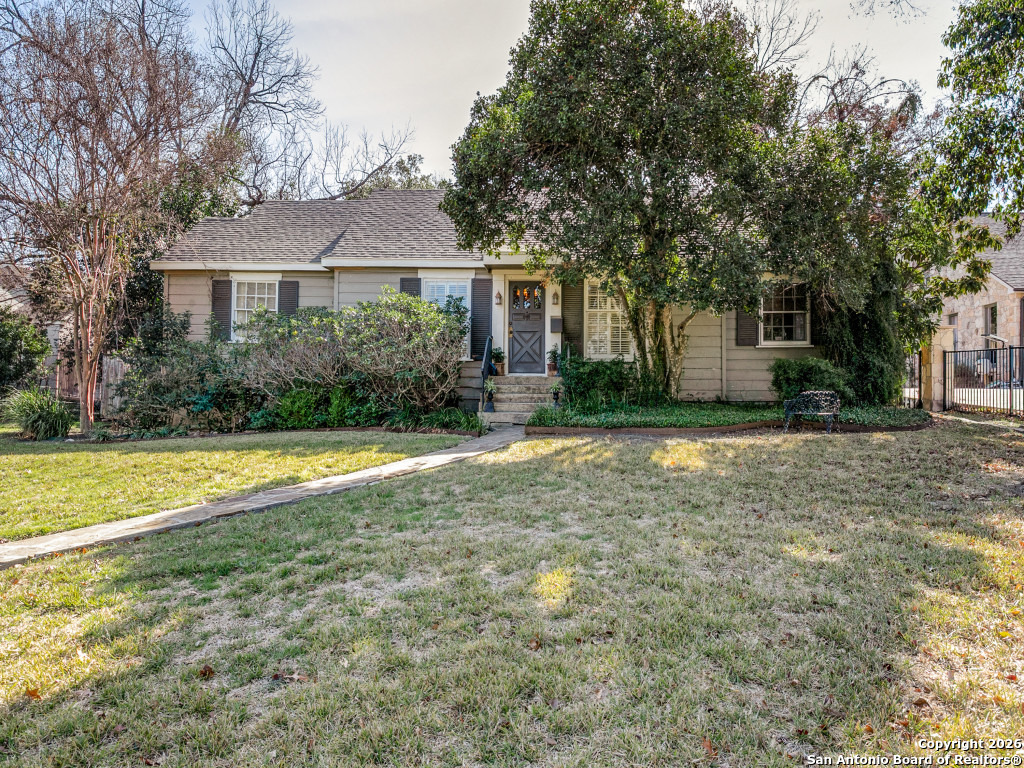 a front view of a house with yard and green space