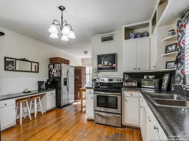 a kitchen with stainless steel appliances a stove sink microwave and cabinets