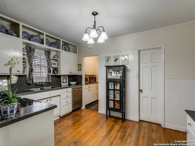 a kitchen with stainless steel appliances a stove top oven a sink and cabinets