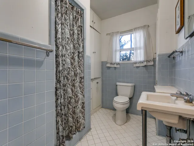 a bathroom with a toilet a sink and a shower