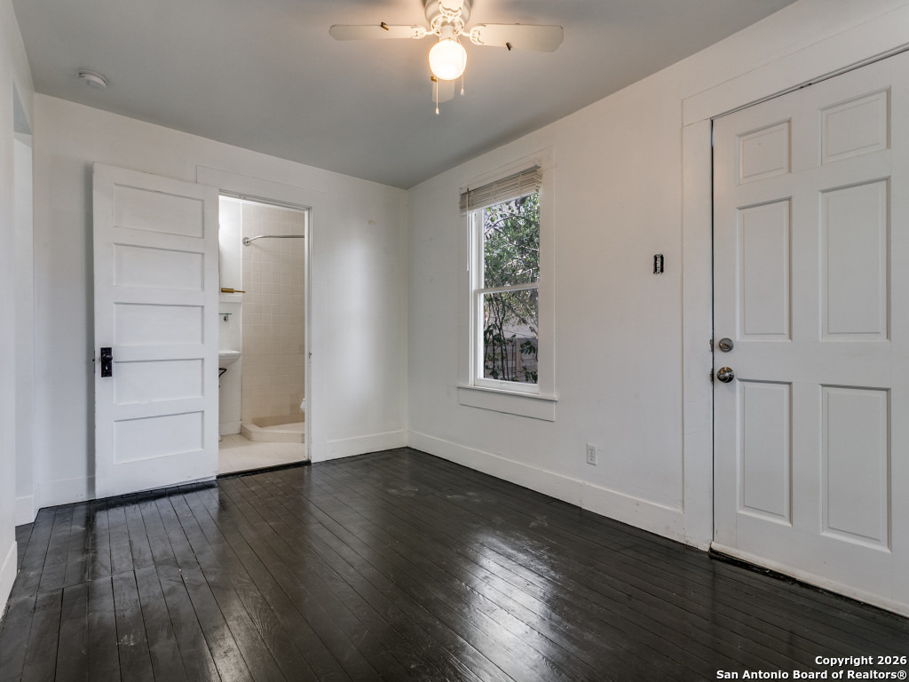 316 Elizabeth Road Terrell Hills, TX 78209 - Photo 21 of 25 an empty room with wooden floor cabinet and windows