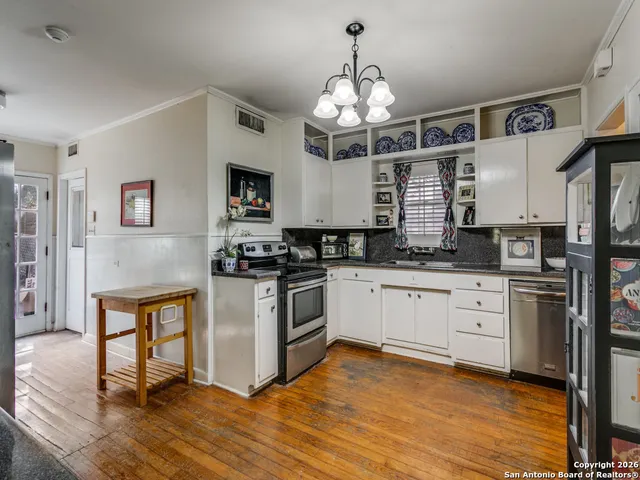a kitchen with stainless steel appliances granite countertop a stove and cabinets