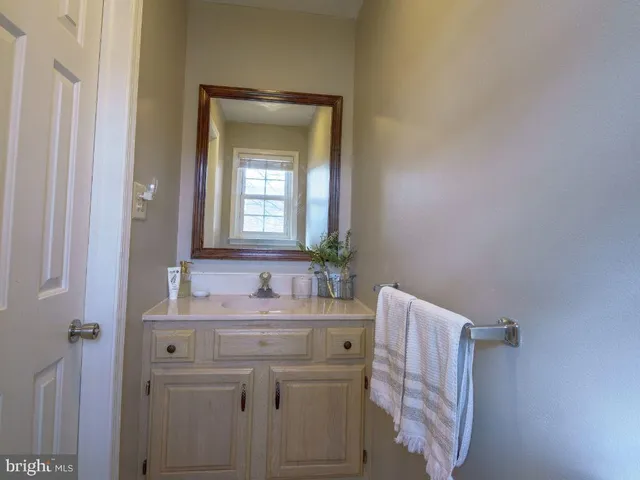 a bathroom with a sink vanity and a mirror