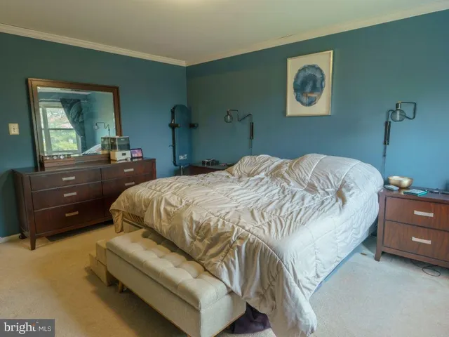 a bedroom with a bed and a dresser in it