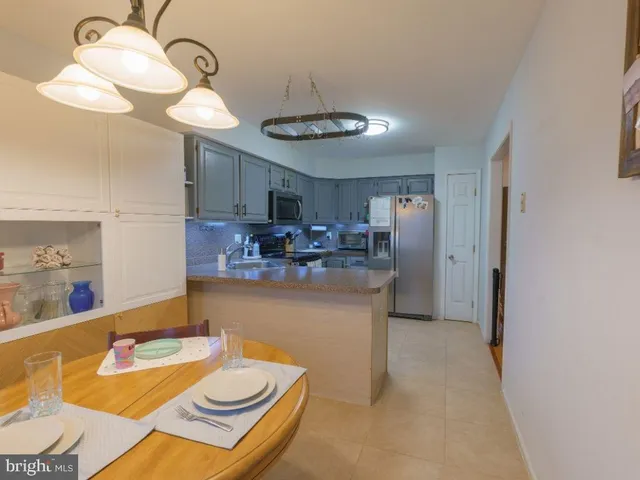 a kitchen with a table and chairs in it