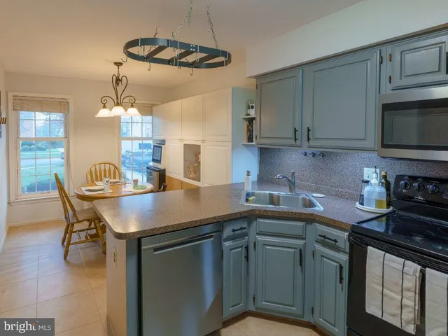 a kitchen with a sink cabinets and appliances
