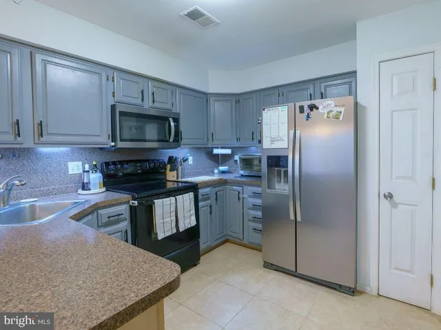 a kitchen with a refrigerator sink and microwave