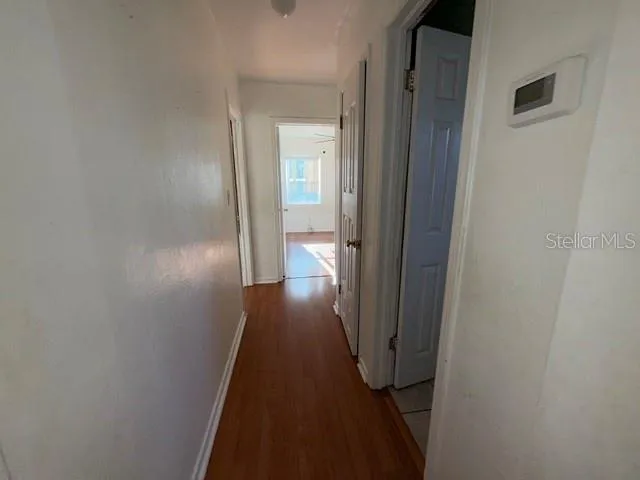 a view of a hallway with wooden floor