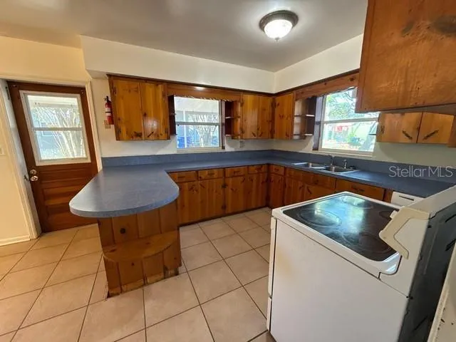 a kitchen with a sink cabinets and window